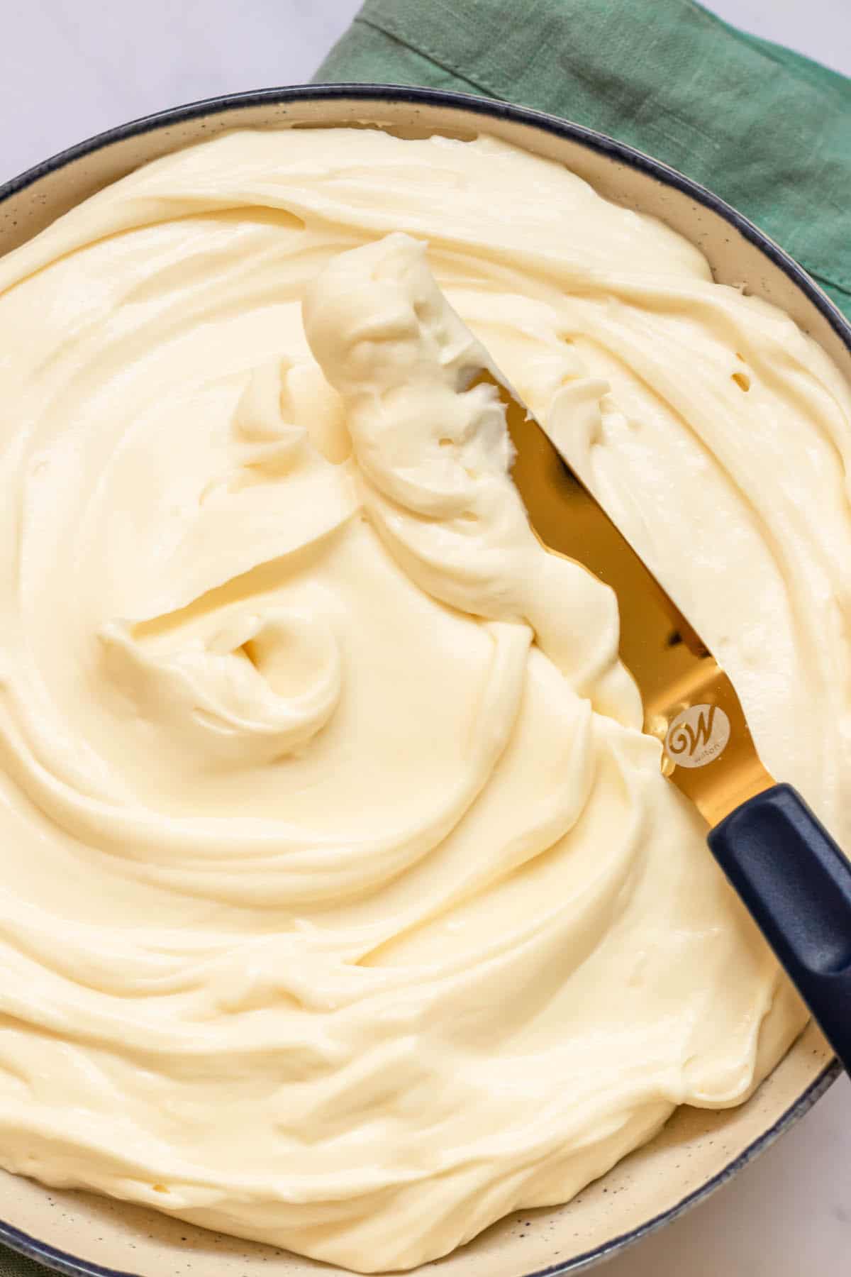 no bake cheesecake with offset staple in a bowl with blue towel