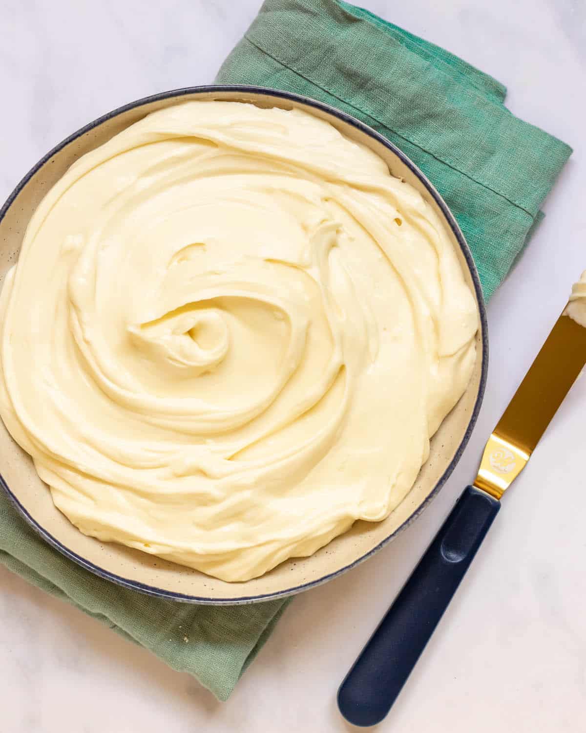 no bake cheesecake filling in a large bowl with blue towel