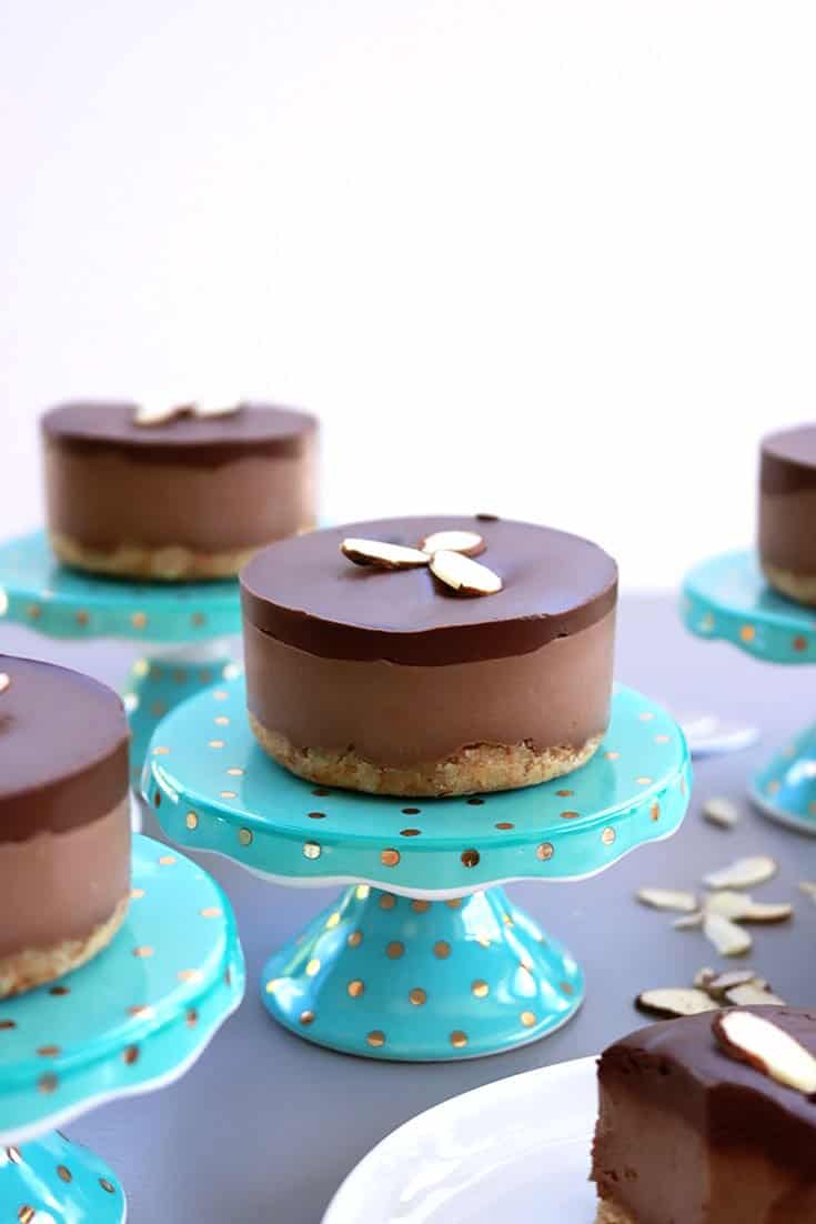 Gluten-free vegan mini chocolate cream cakes topped with sliced almonds