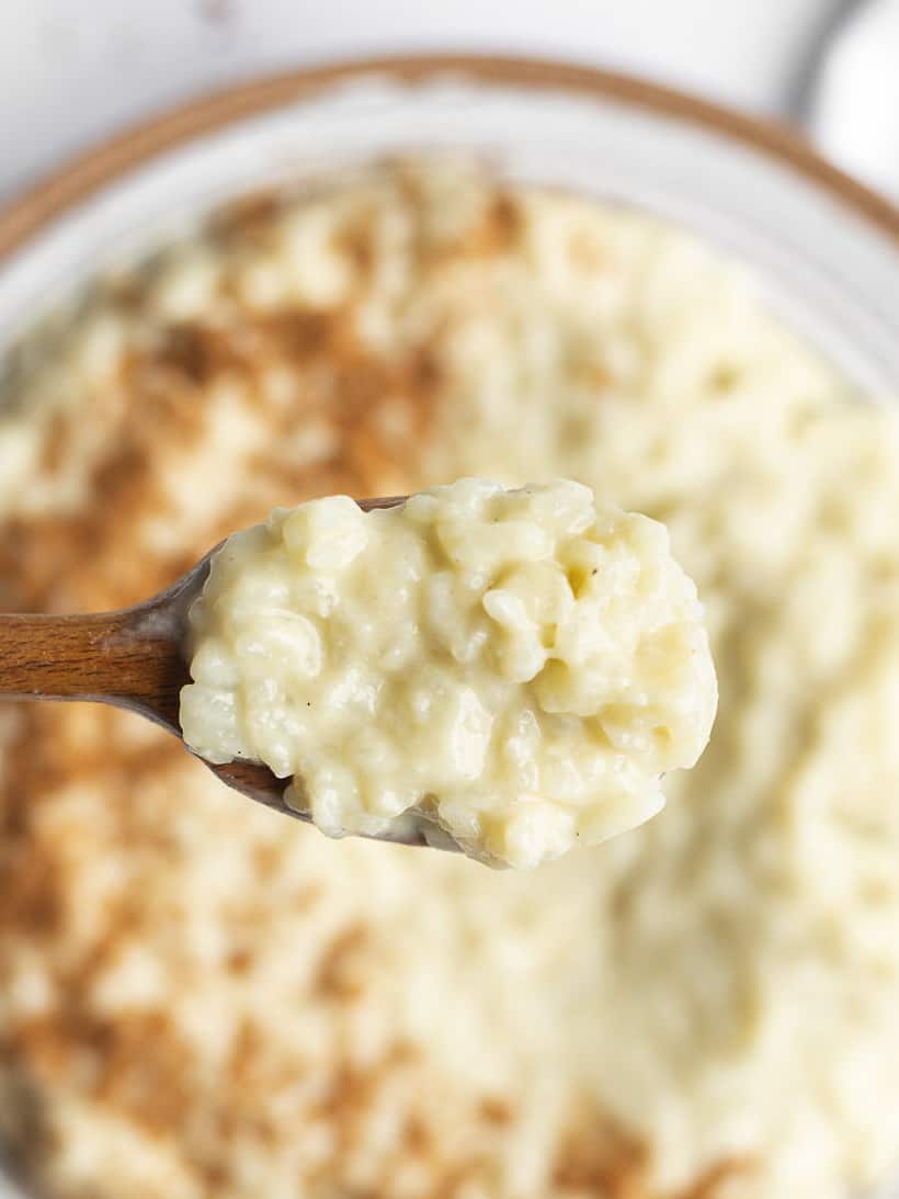 oat milk rice pudding on a wooden spoon