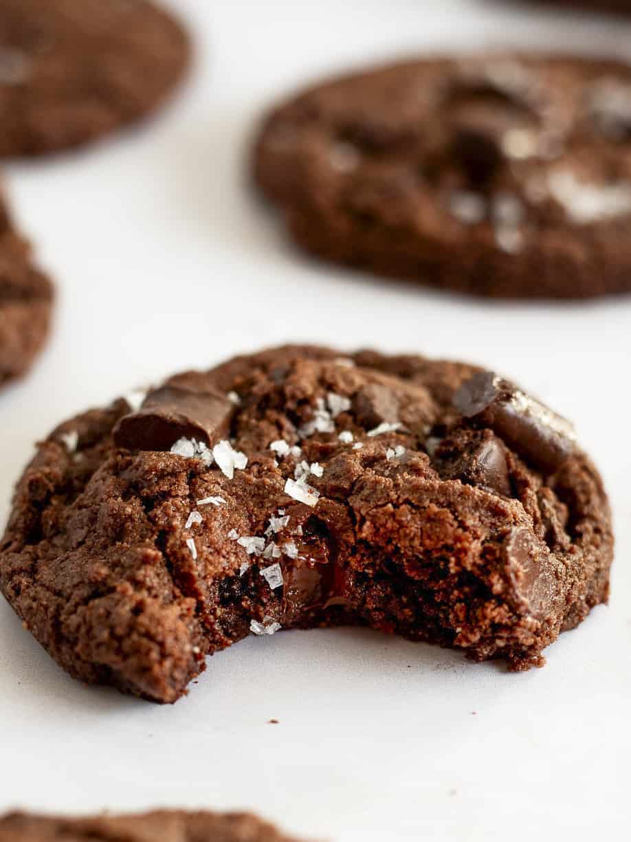 gluten free double chocolate chip cookie on the counter with a bite out of it 