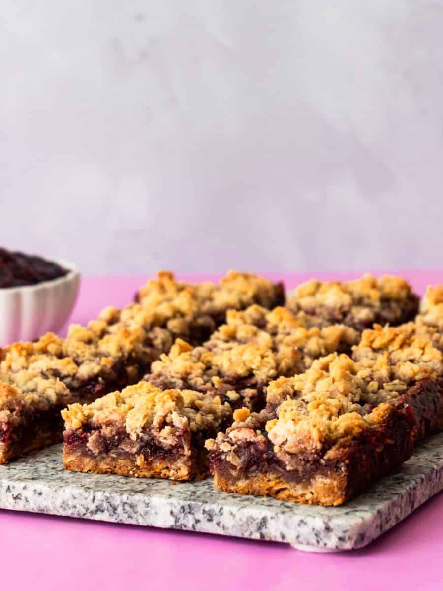 raspberry oatmeal bars sliced on a marble slab