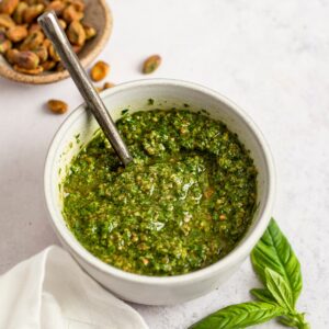 pistachio pesto in a small bowl with a spoon