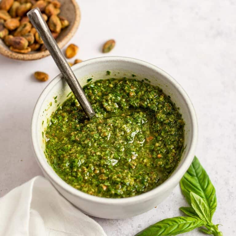 pistachio pesto in a small bowl with a spoon