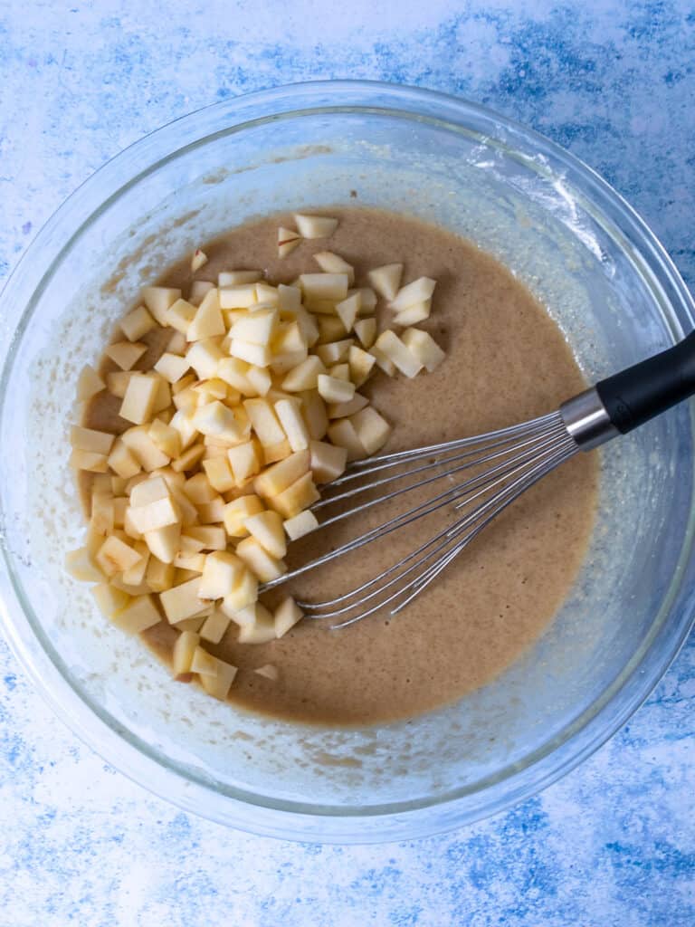 adding apples into gluten free apple muffin batter