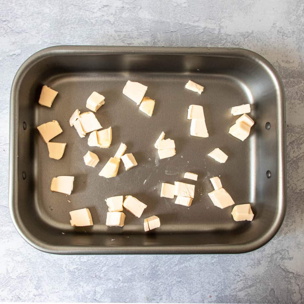 cubed butter in baking pan 
