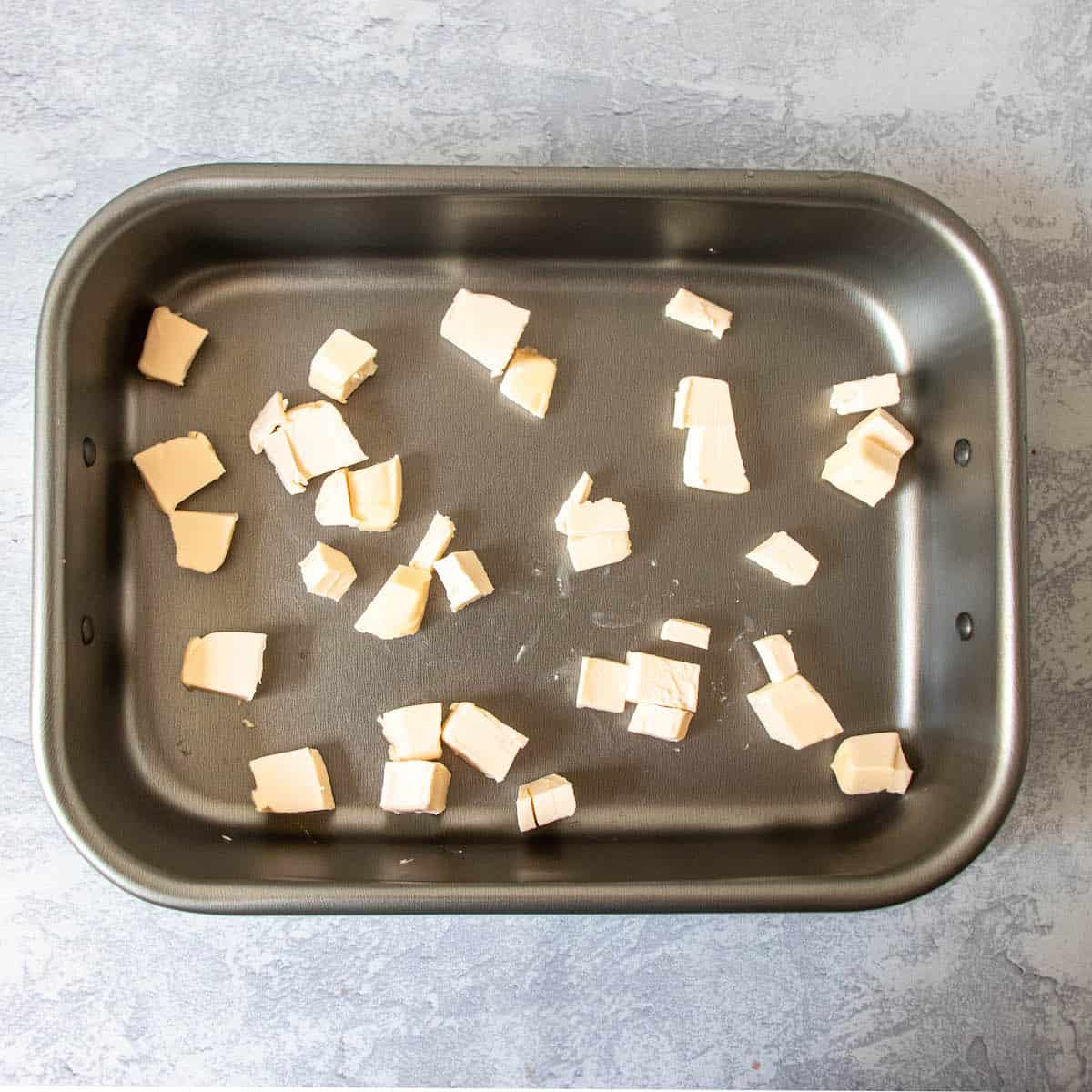cubed butter in baking pan