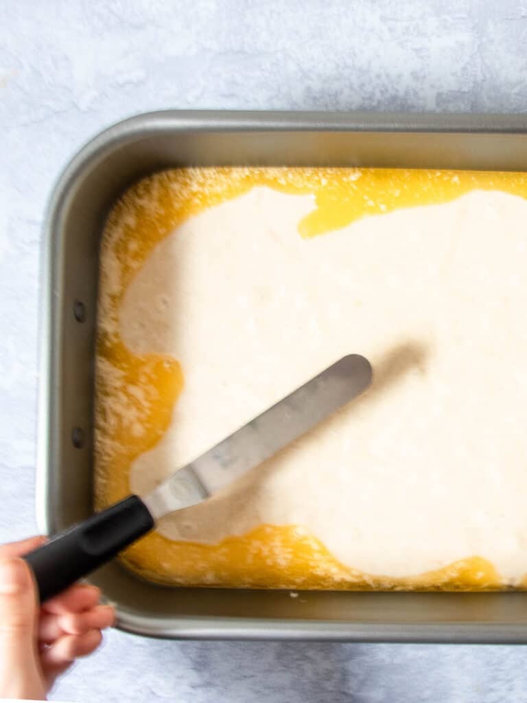 spread batter on top of butter in pan