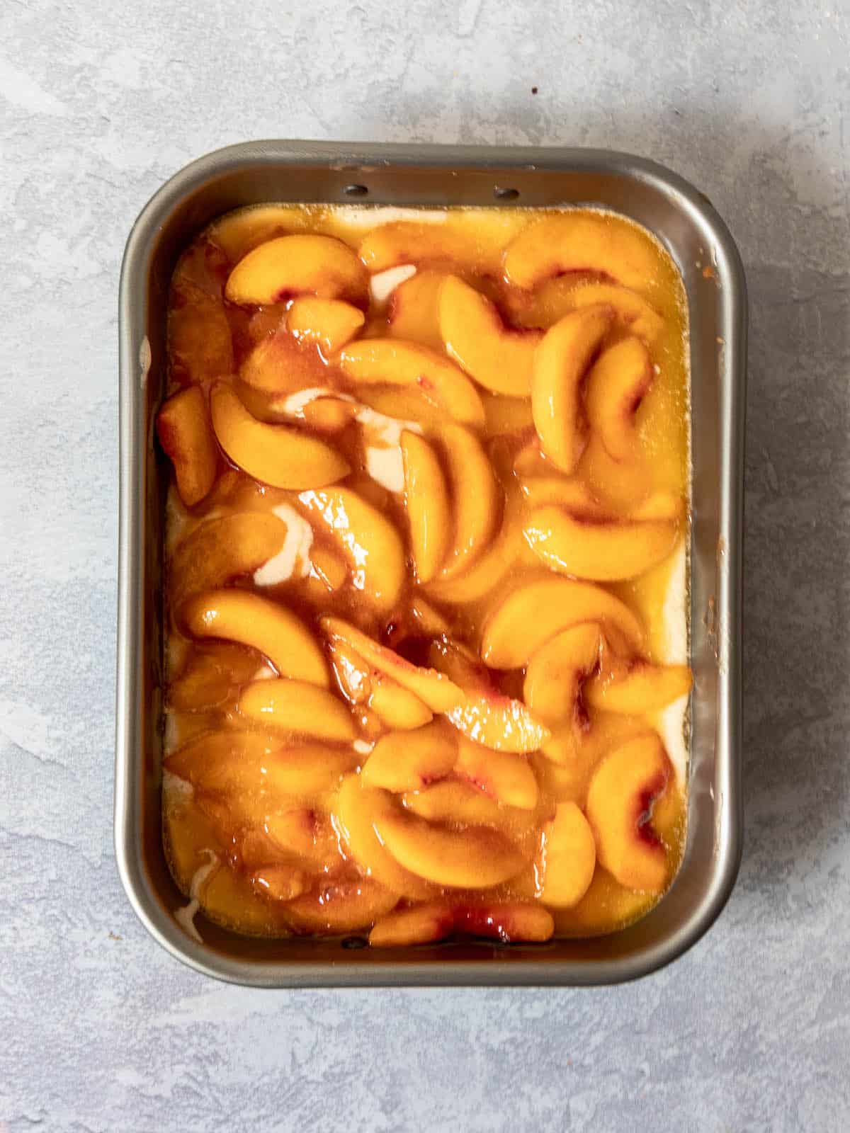 gluten free peach cobbler in pan before baking