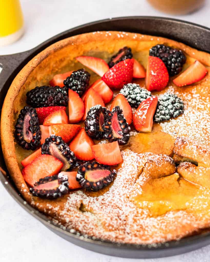 Best Gluten Free Dutch Baby (German Pancake) in Cast Iron Skillet topped with berries