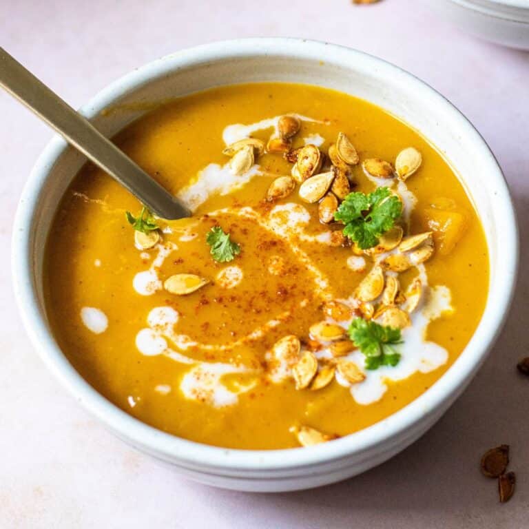 miso butternut squash soup in stoneware bowl with metal spoon