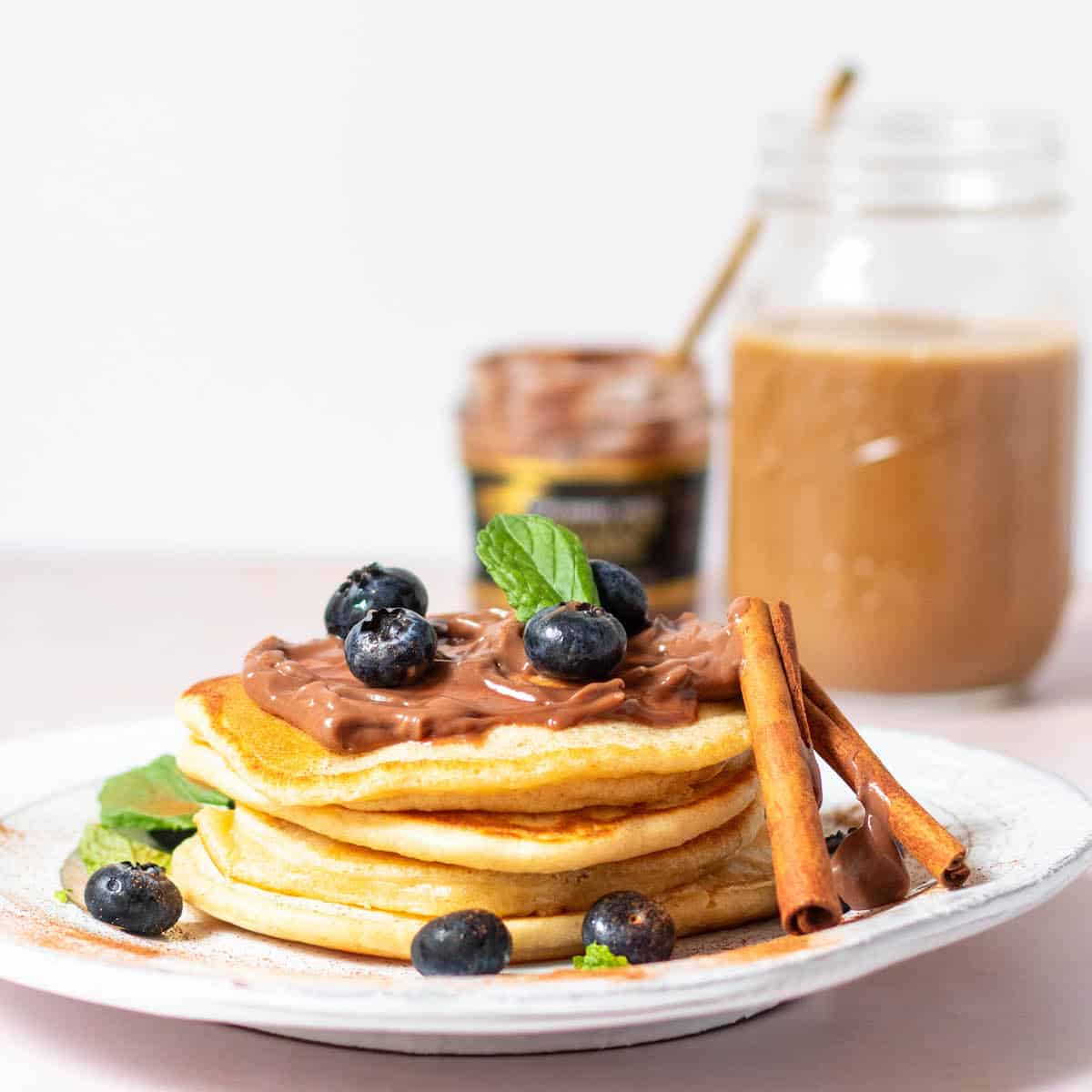 buttermilk pancakes with zen chocolate pudding as garnish with coffee in the background