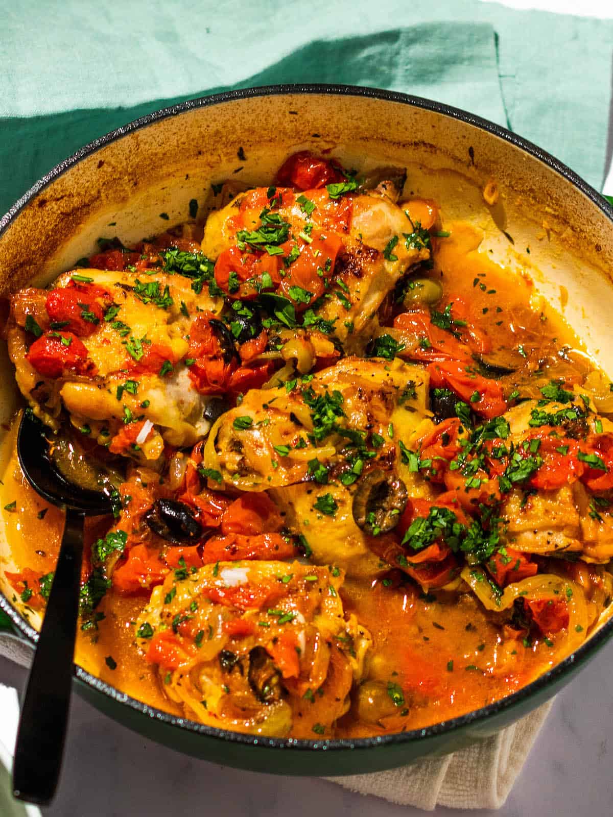 Chicken Thighs with Tomatoes and Olives with a spoon