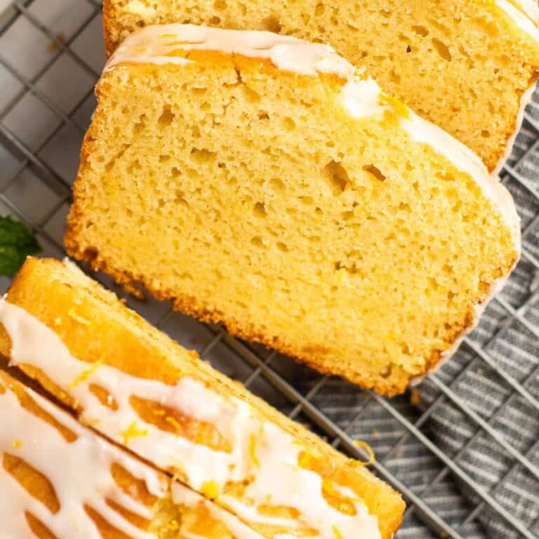 two slices of gluten free lemon drizzle cake on a cooling rack