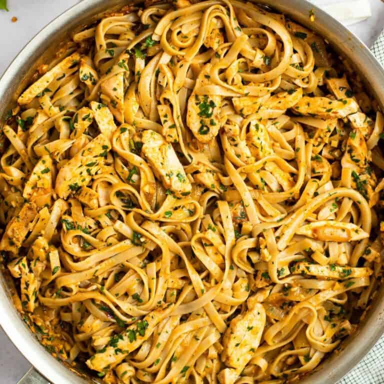 close up spicy chicken pasta in an all clad skillet