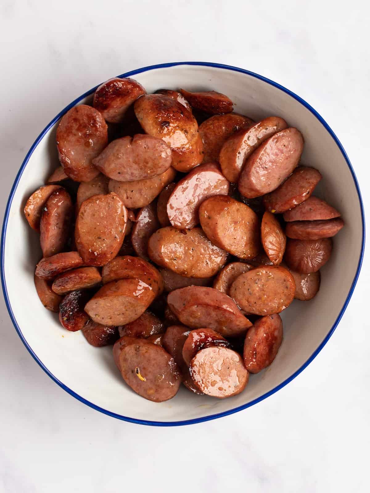 Cooked sausages transferred to a bowl 