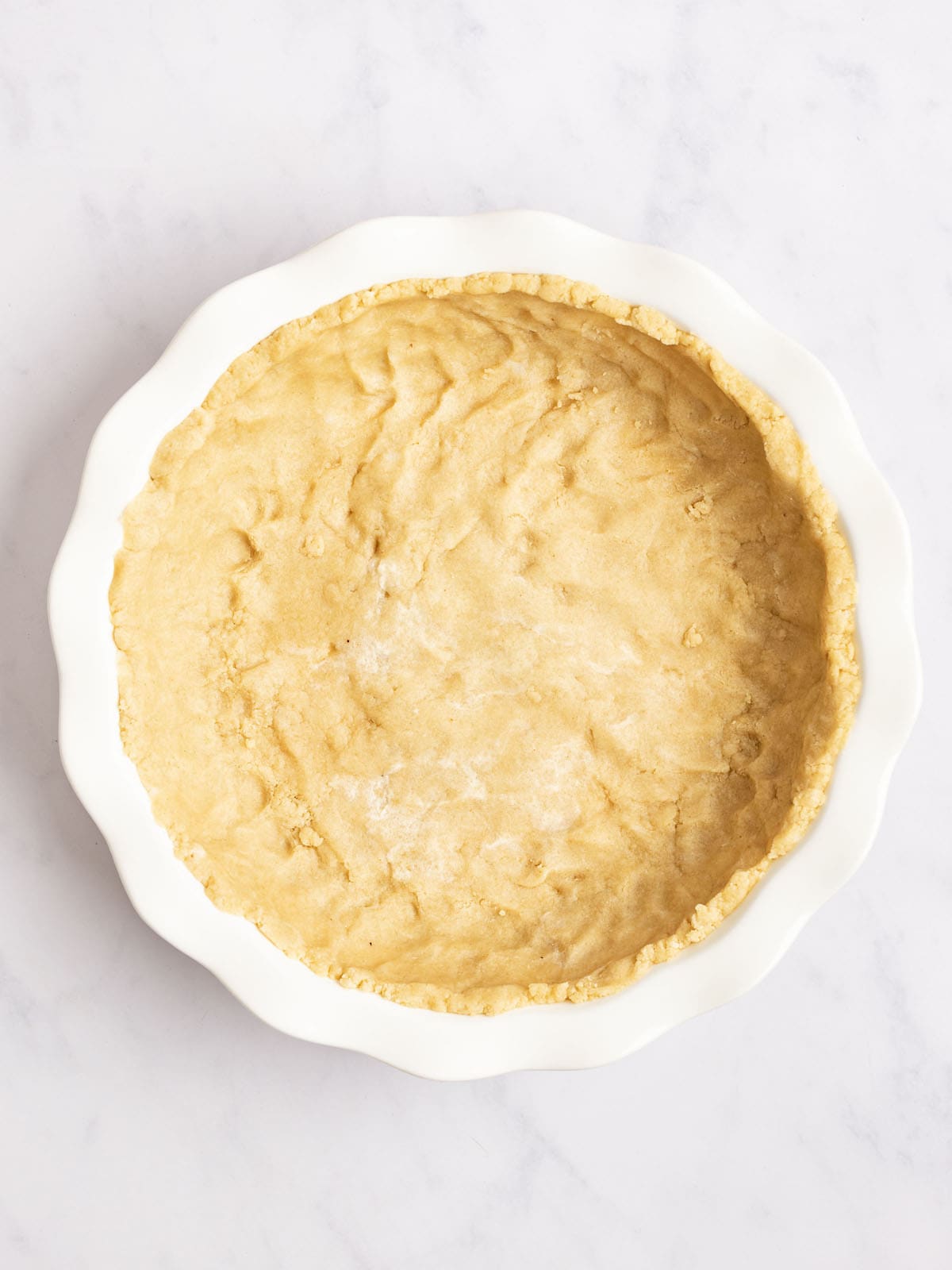 pie crust fitted to pie pan