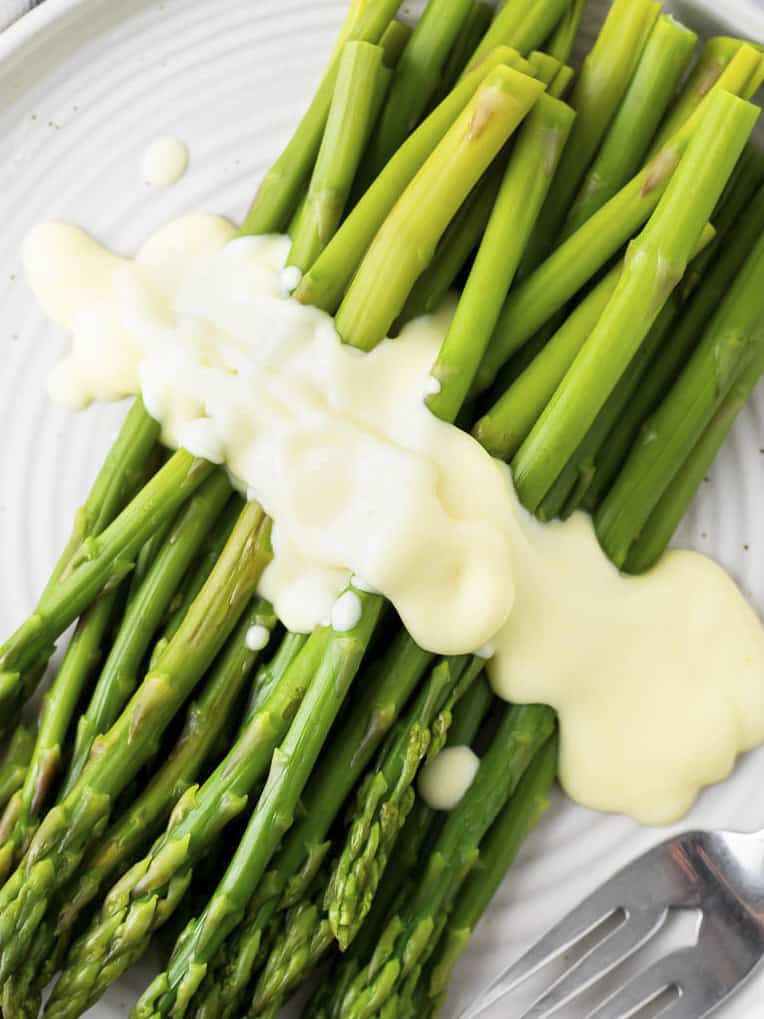 mousseline sauce drizzled over asparagus