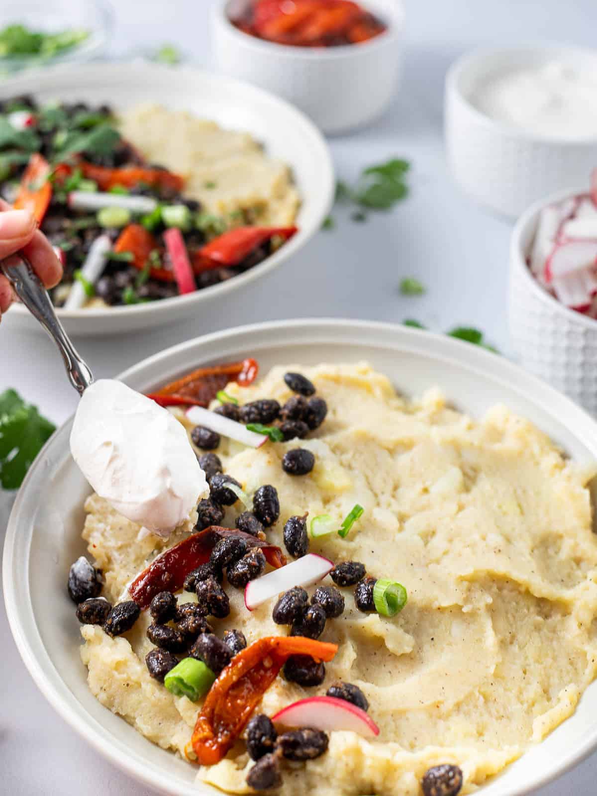 decorating mashed potato bowl with toppings