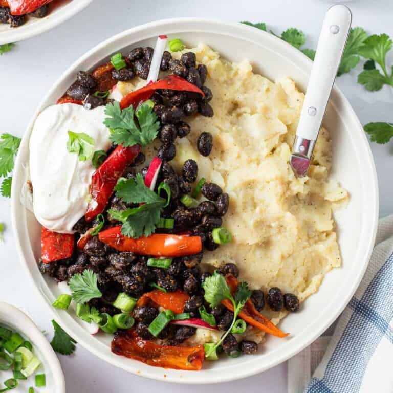 loaded mashed potato bowl with toppings and a spoon