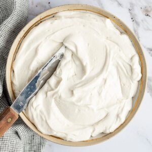 vegan cheesecake frosting in a bowl with spatula