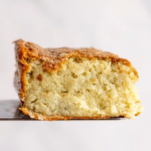 potato kugel slice lifted on a knife
