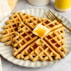 oat flour waffles stacked on a plate