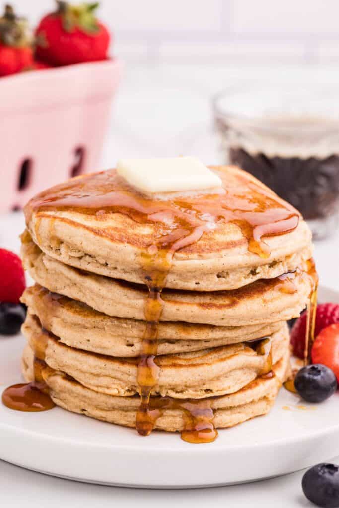 gluten-free oat flour pancake stack with maple syrup and fresh berries