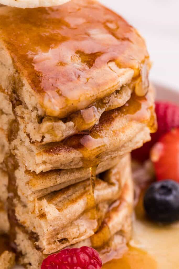 gluten-free oat flour pancakes stacked high with butter melting on top