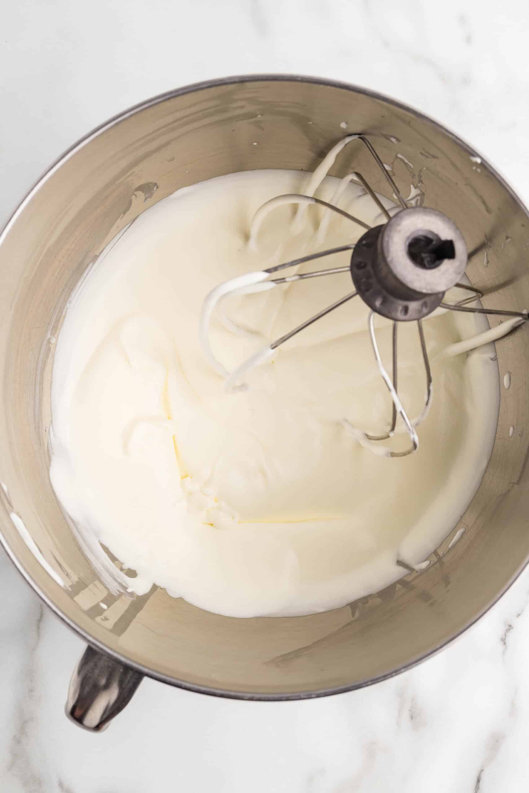 Heavy cream whipped to medium-stiff peaks in a stand mixer bowl with a whisk attachment